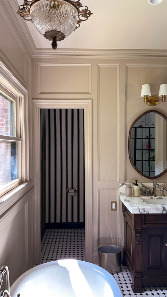 my primary bathroom renovation reveal. farrow & ball's jitney paint, striped wallpaper, brass light fixtures.