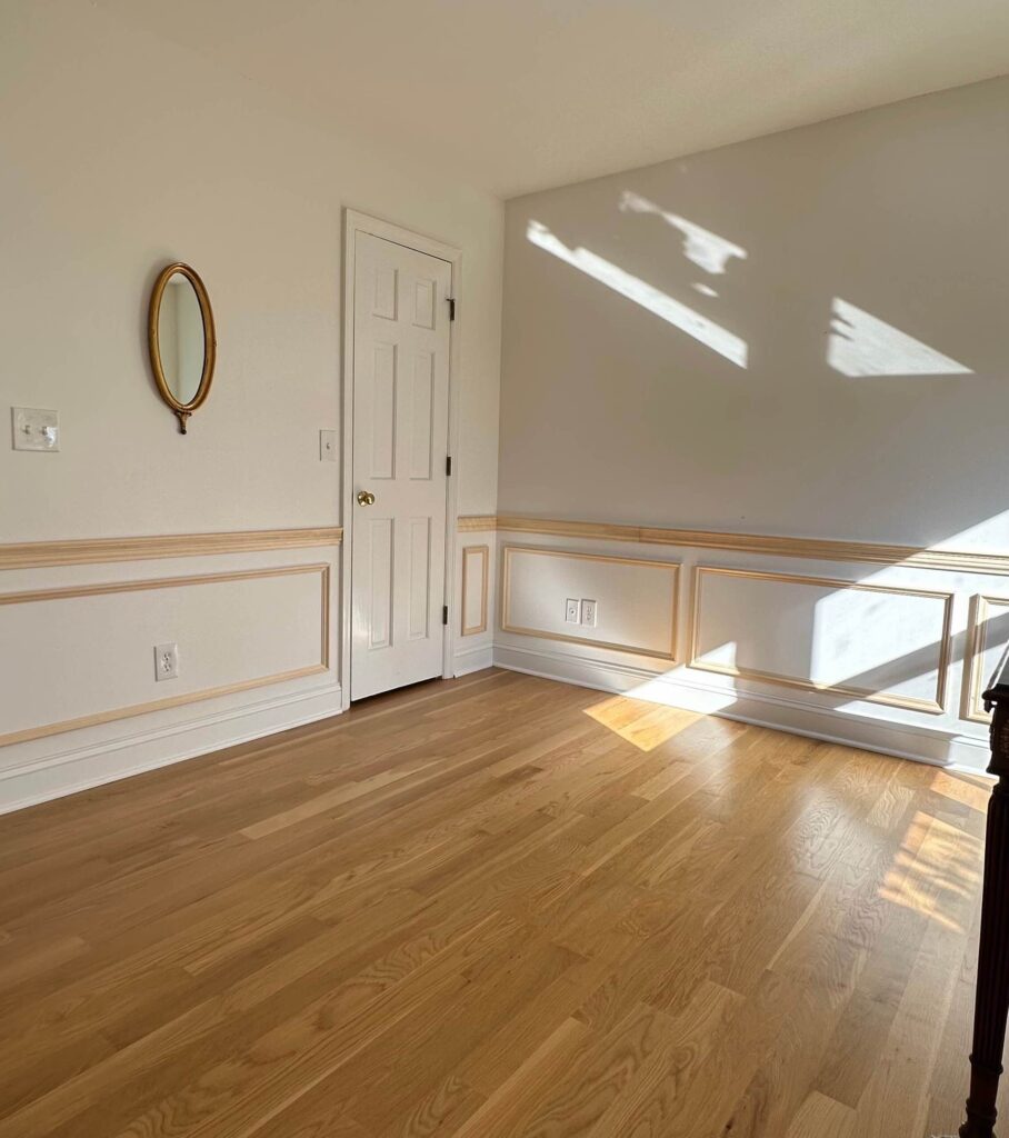 a home office with installed picture frame molding and chair rail