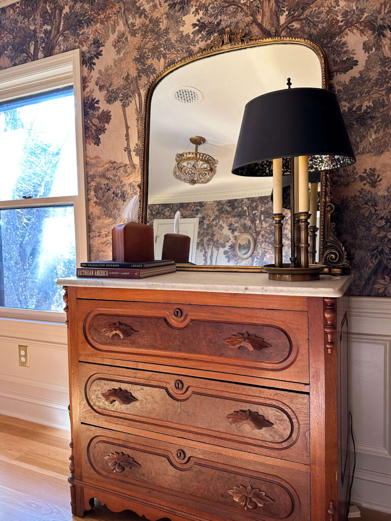 Vintage moody traditional home office with landscape mural, antique eastlake dresser with marble top and vintage lamp
