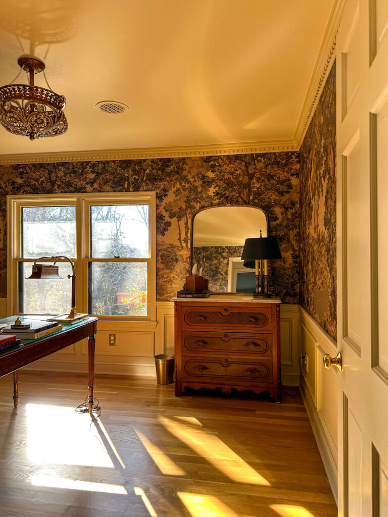 Vintage moody traditional home office with landscape mural, antique dresser, large mirror and vintage lamp
